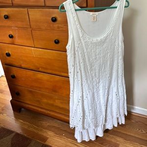 White sleeveless dress with white cotton underlay.